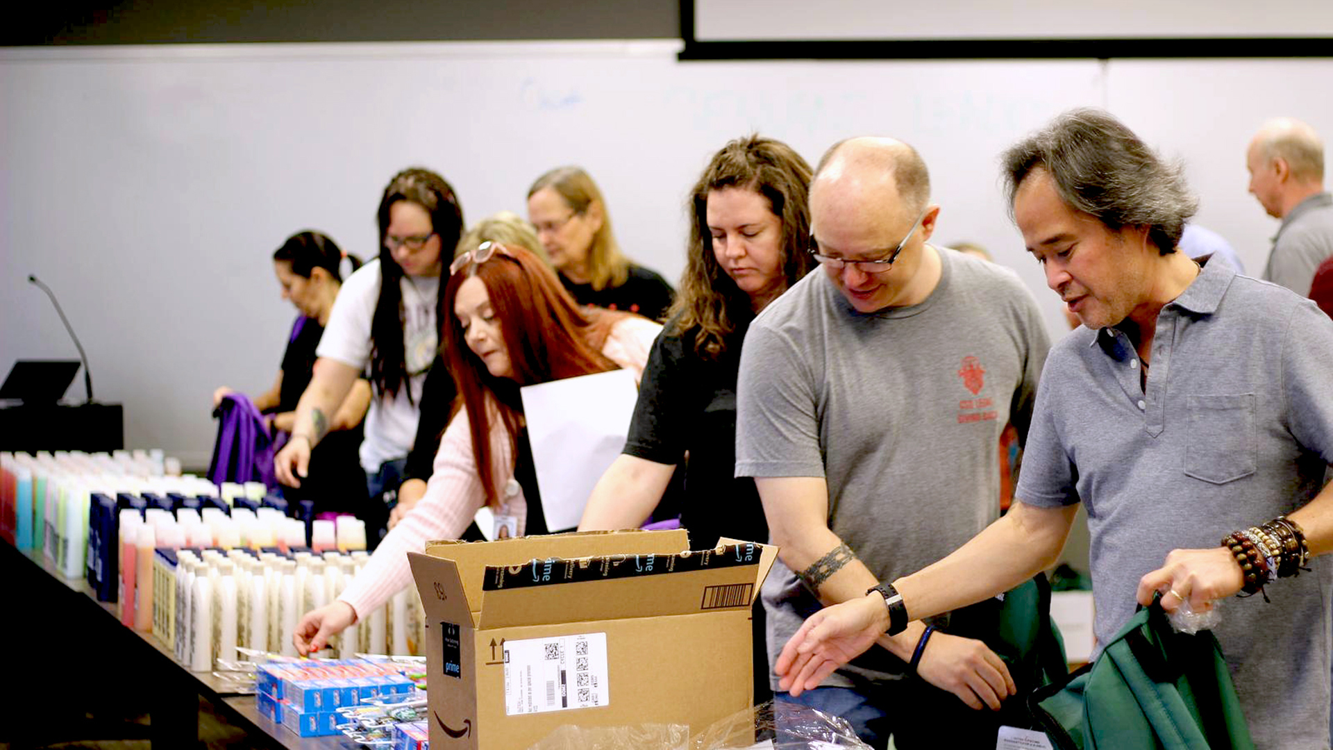 CFO Hai Tran and other CSG employees packaging supplies in a volunteer activity