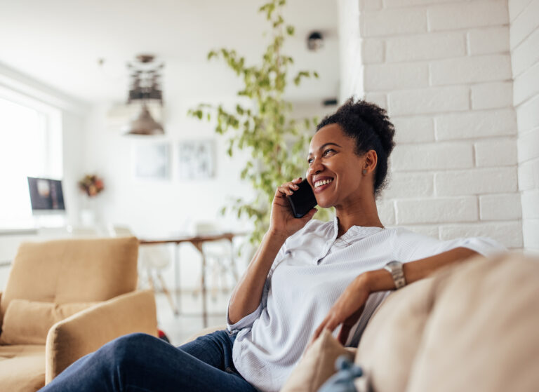 african female spending day at home using phone