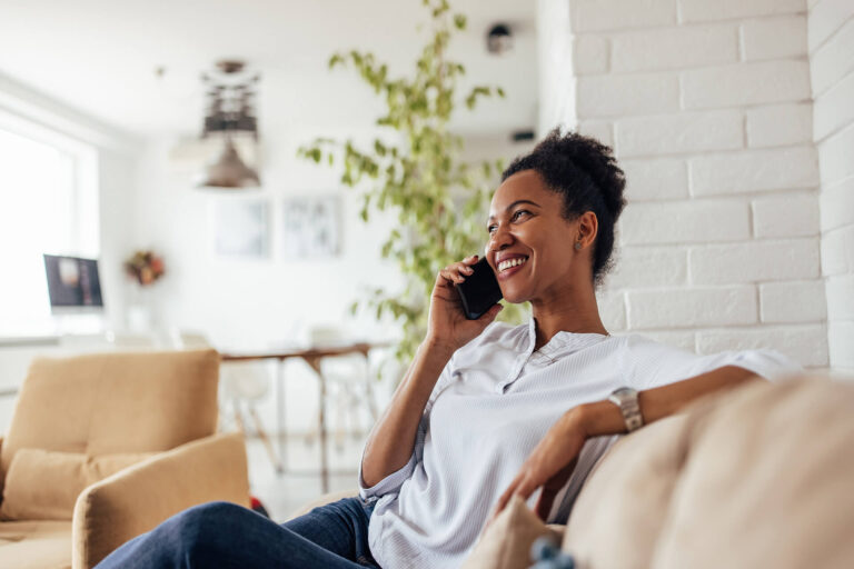 african female spending day at home using phone