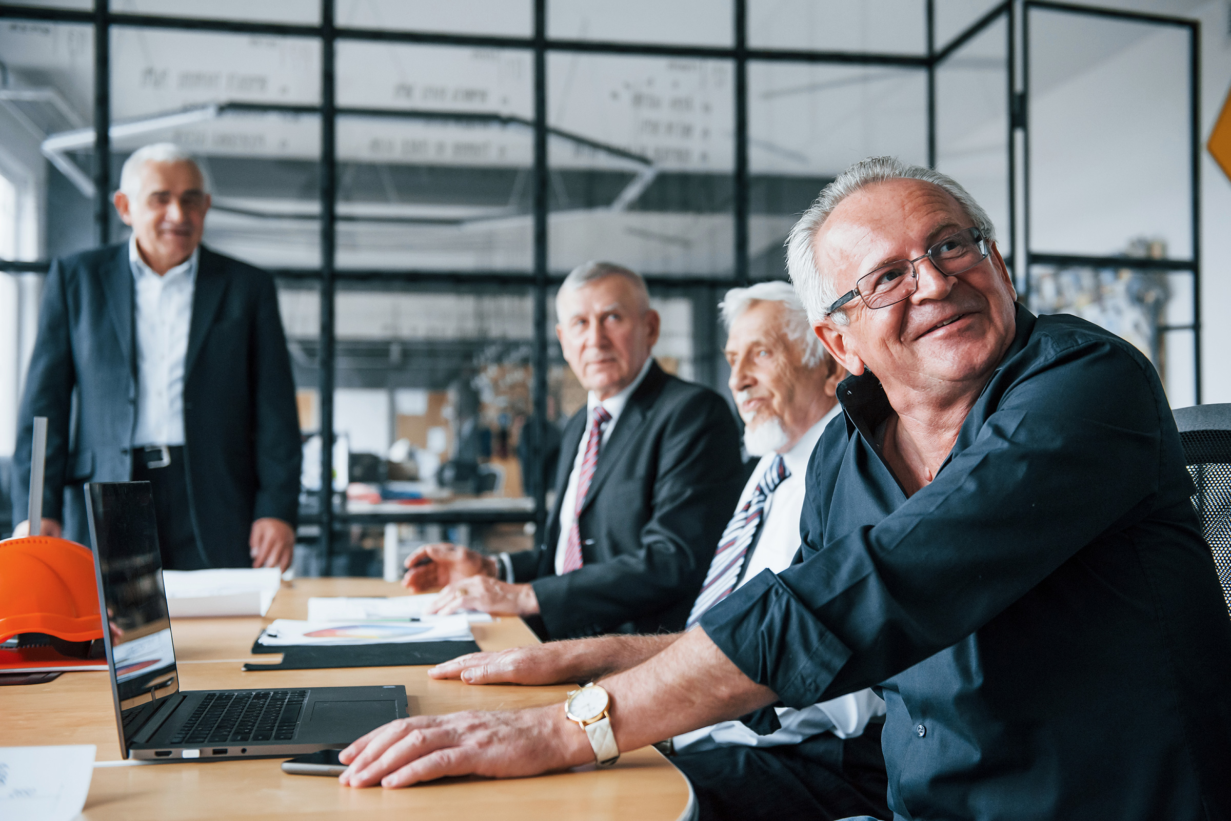aged team of elderly businessman architects have a meeting
