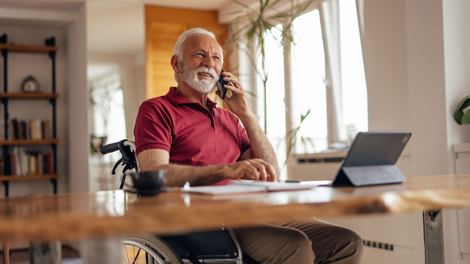 Older business man on the phone in his home office