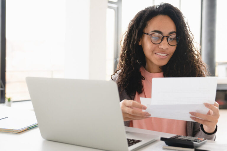 Happy African female checking her billing statement