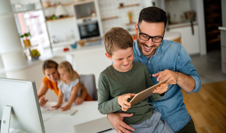 Happy father and son sharing a tablet