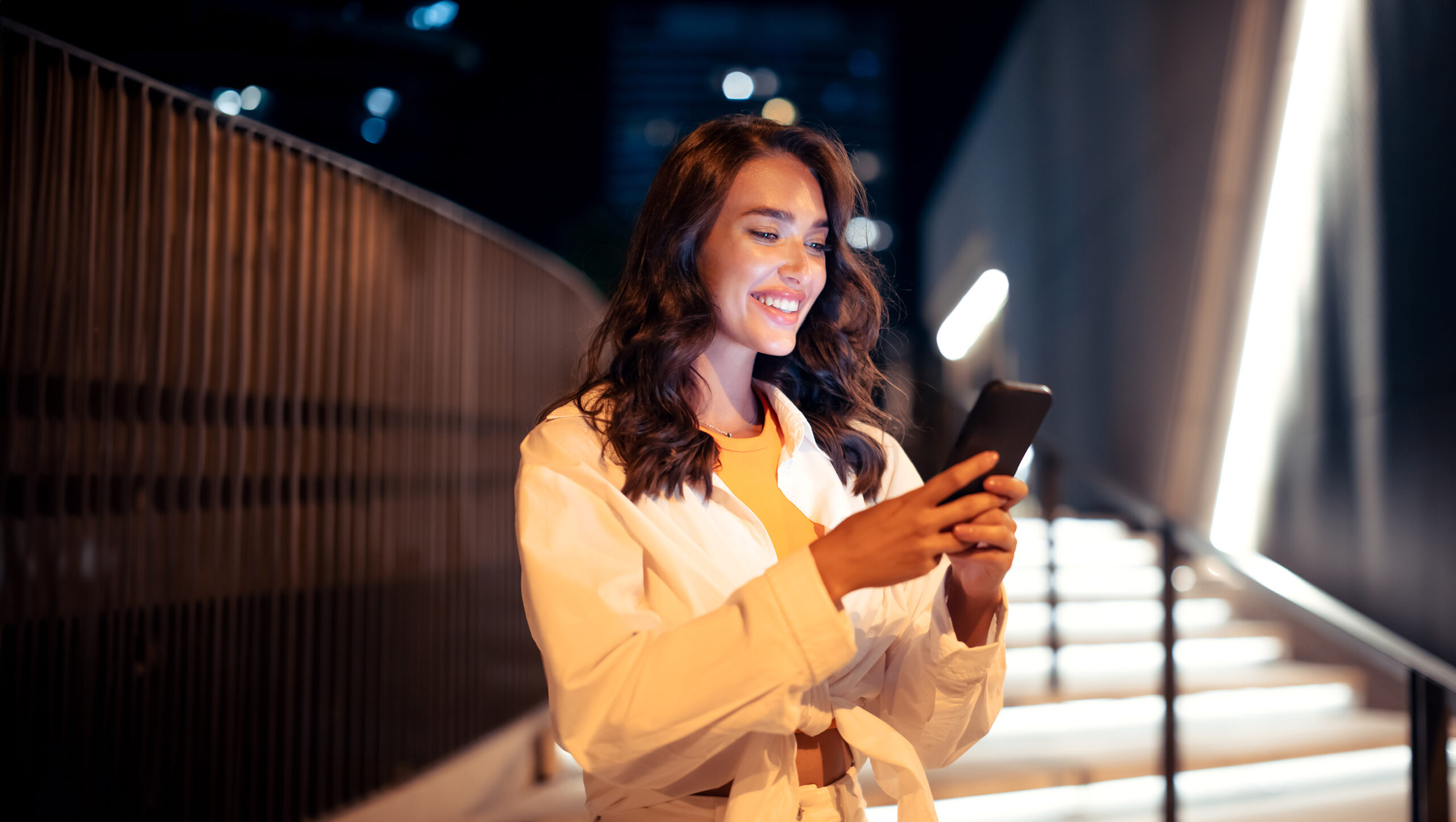 happy young female tourist walking through night