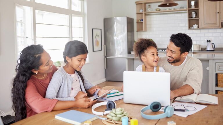 Family doing homework together at kitchen table