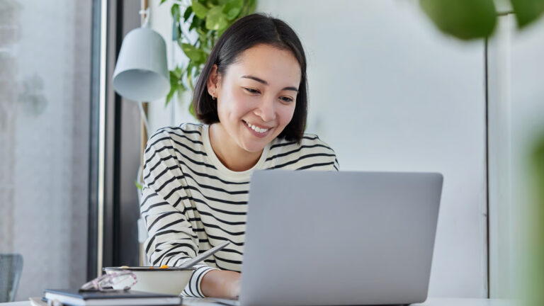 woman typing on laptop working from home