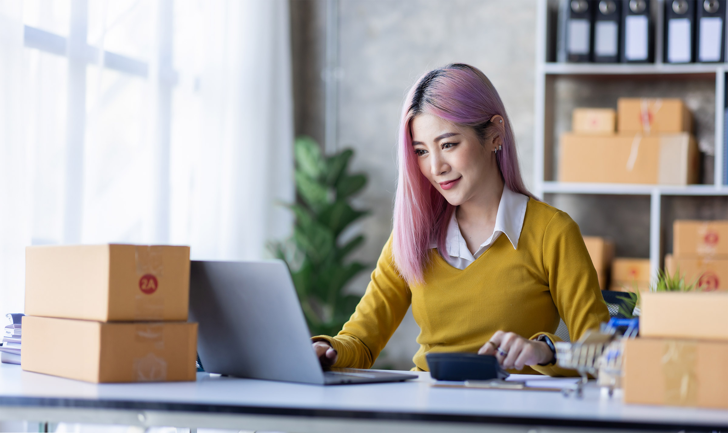 Young Asian woman fills online orders