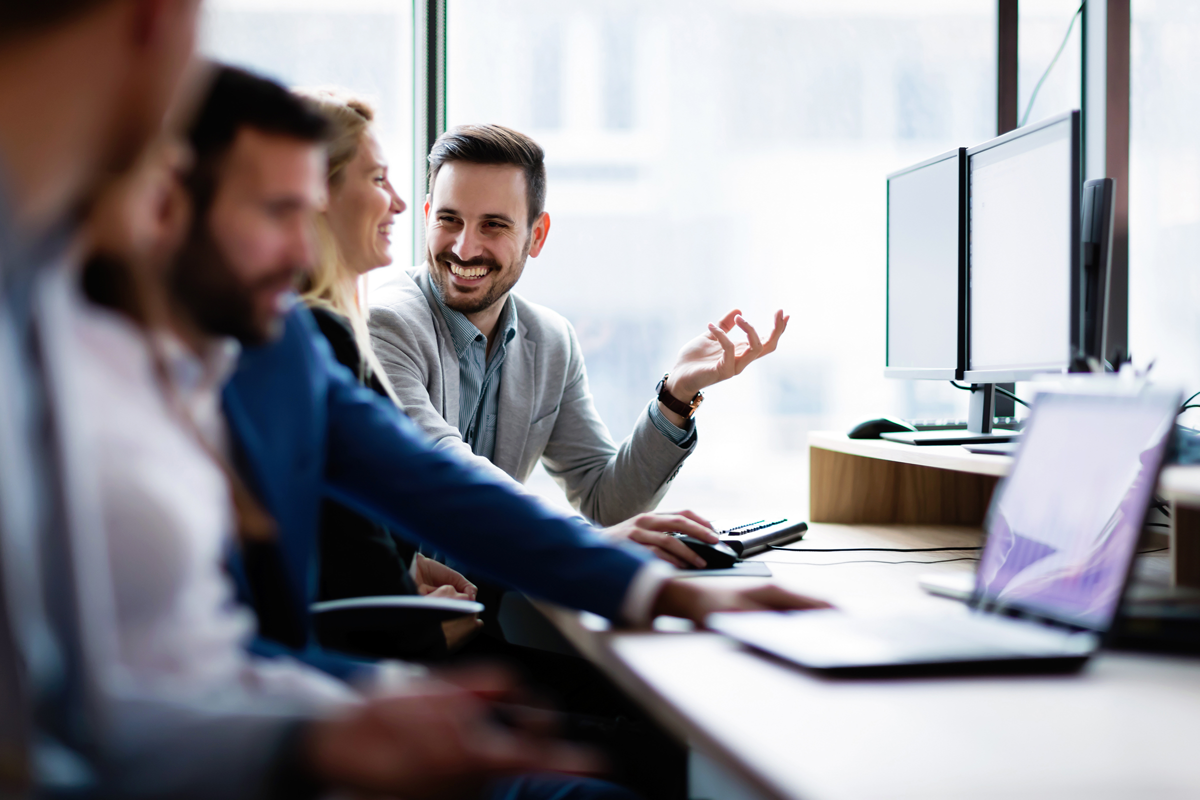 young businesspeople working on computer in office